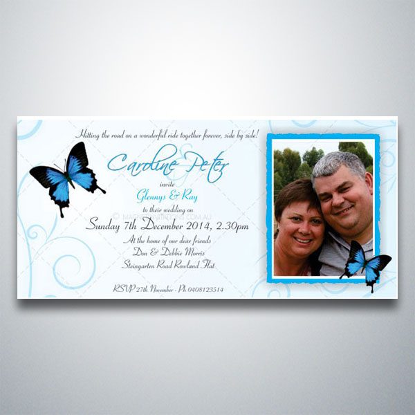 Lovely wedding invitation featuring blue butterflies, swirls and a photo of the bride and groom