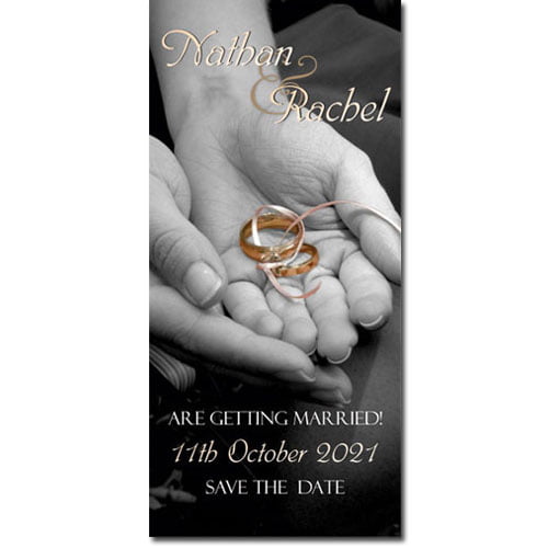 Two hands holding gold wedding rings